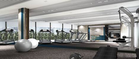 Un gimnasio moderno con cintas de correr, pelotas de ejercicio y máquinas de pesas, con ventanas amplias y vista a la ciudad.