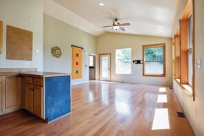 Enjoy a room with a high ceiling, ceiling fan, and large window.