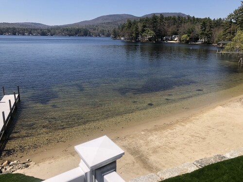 A quiet cove, the sunset and a sandy beach, on Lake Winnipesaukee