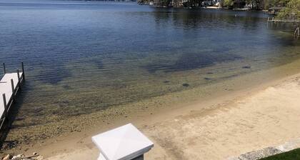 A quiet cove, the sunset and a sandy beach, on Lake Winnipesaukee