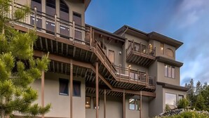 A multi-story building with a balcony and a staircase. - Moose on the Loose: Private Hot Tub, Mountain Views, Quick Ski Access (Breckenridge)