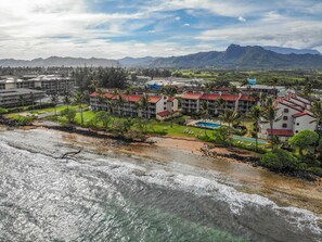 A coastal hotel with multiple buildings, a swimming pool, and a beach area. - Kapaa Shore Resort A309, Oceanfront, Walk to Shops, Restaurants, Beaches (Kapaa)