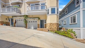 A residential building with a garage, a balcony, and a stone facade. - 217BA: Lovely 3 bdrm, 2.5 Bath, Ocean Views, Wifi (Avalon)