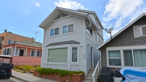 A two-story house with a garage, a satellite dish, and a small garden area. - 337CA: Charming 2-bdr Avalon cottage on the flats (Avalon)