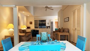 A dining area with a white table and blue chairs, a blue and white striped tablecloth, and a ceiling fan. - 337CA: Charming 2-bdr Avalon cottage on the flats (Avalon)