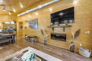 A modern interior with a kitchen, dining area, and a fireplace.
