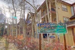 Experience the serene atmosphere of Lodge at Riverbend, nestled among deciduous trees.