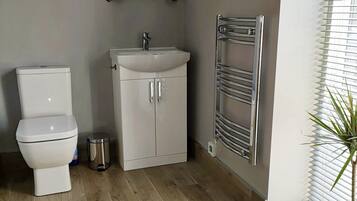 Een douche, een haardroger, handdoeken, toiletpapier