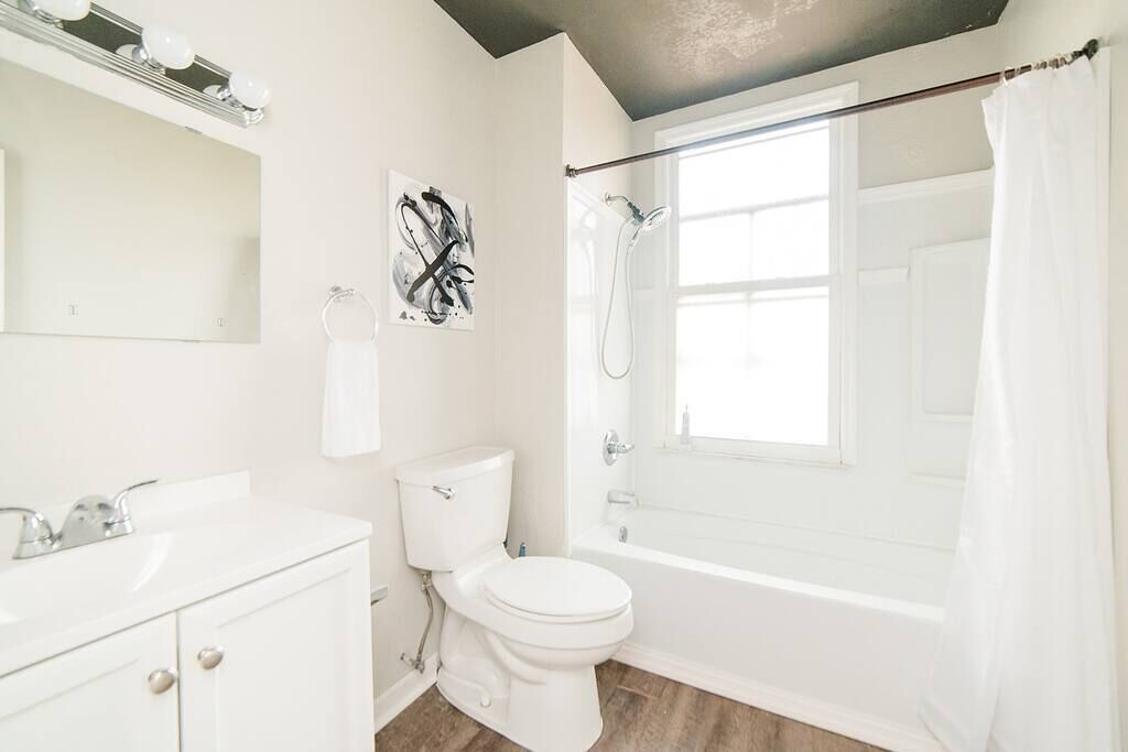 Bathtub, hair dryer, towels, shampoo