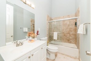 Bathtub, hair dryer, towels, shampoo