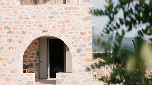 A stone building with a pool, an archway entrance, and a view of the landscape. - Dione Villa 3: private pool - amazing sea view - traditional minimal stone villa (STOUPA)