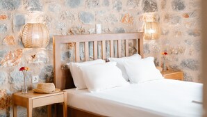 A bed with white linens, a wooden headboard, and two bedside lamps. - Dione Villa 3: private pool - amazing sea view - traditional minimal stone villa (STOUPA)