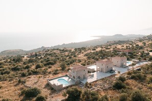 A coastal property with a swimming pool, stone buildings, and a view of the sea. - Dione Villa 3: private pool - amazing sea view - traditional minimal stone villa (STOUPA)