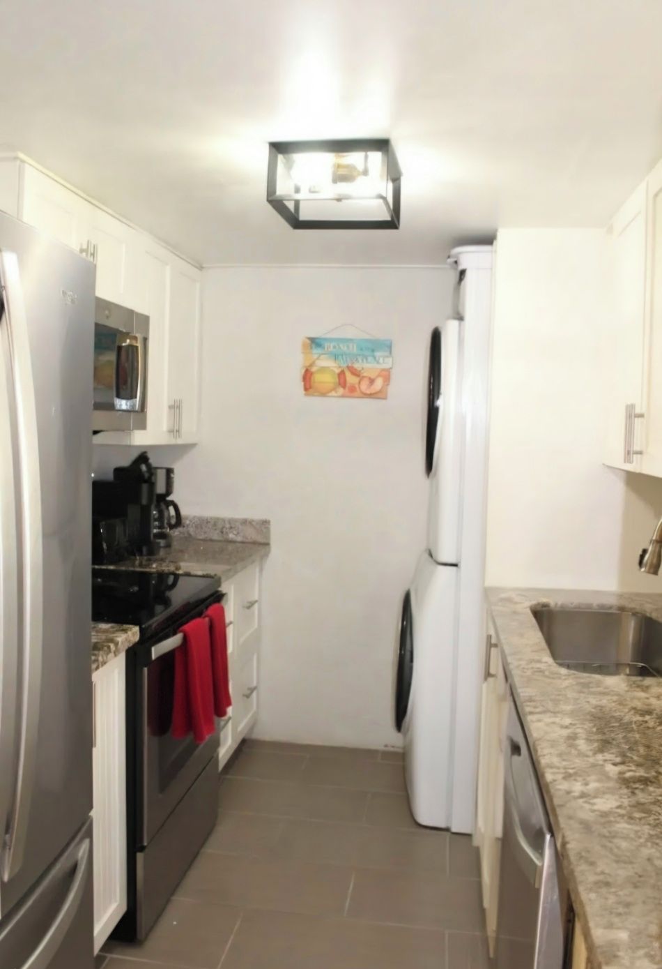 Full size appliances in galley  kitchen, with washer & dryer