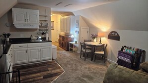 A compact living space with a kitchenette, dining area, and a cozy seating area. - EXCLUSIVE LARGE 2 BEDROOM SUITE W/THEATER ROOM + KITCHEN  (Cleveland)