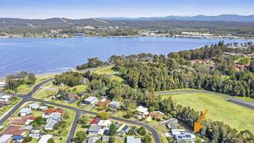 House backs onto a tidal creek with playing field beyond.