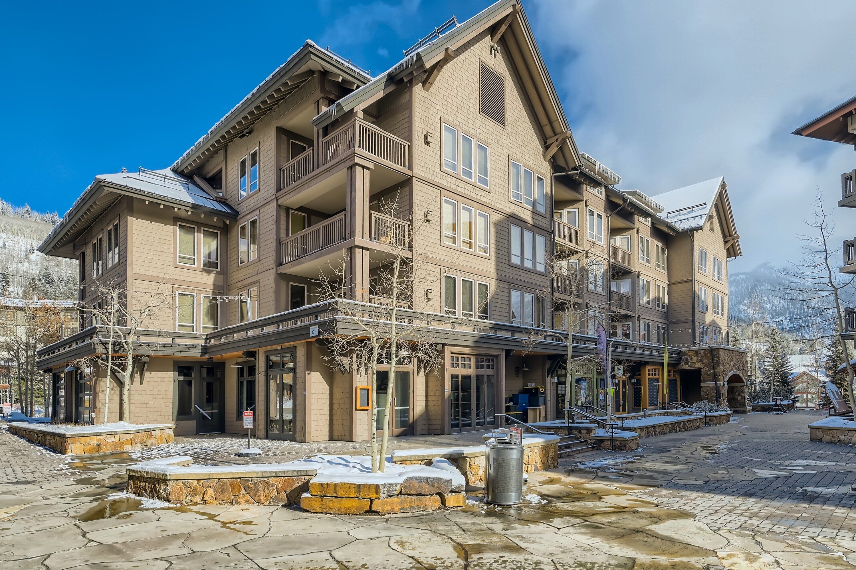 A multi-story hotel with a traditional architectural style, featuring balconies and large windows.