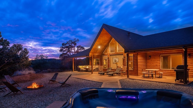 A log cabin with a hot tub, outdoor seating, and a fire pit. - Skyfall Cabin | Private Hot tub | Zion NP (Orderville)