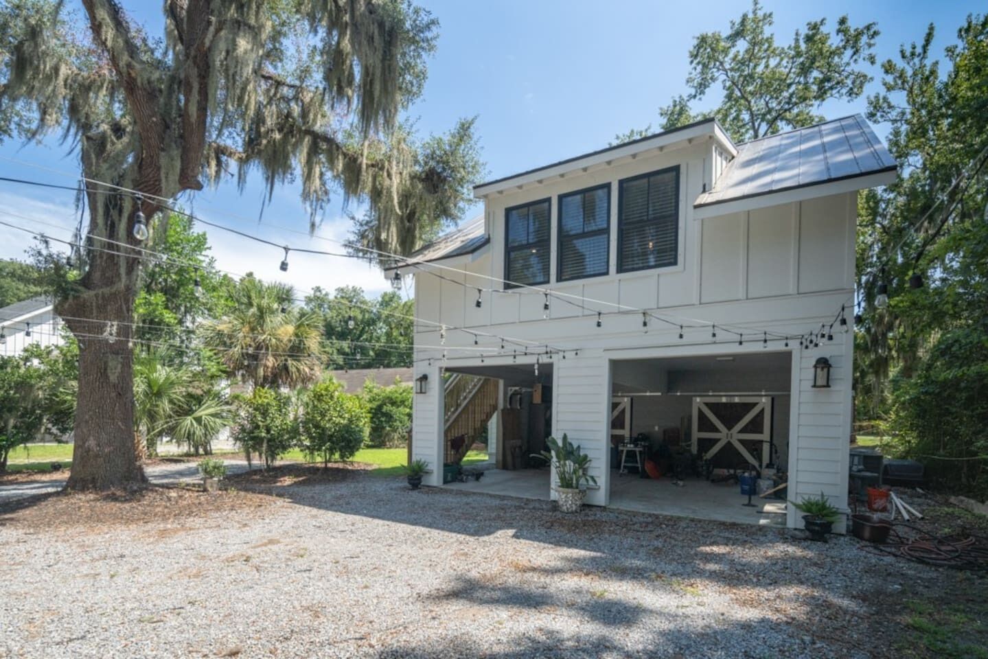 A two-story house with a covered garage and a patio area.