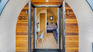 Un arco de entrada a una habitación con una cama, una mesa y una silla.