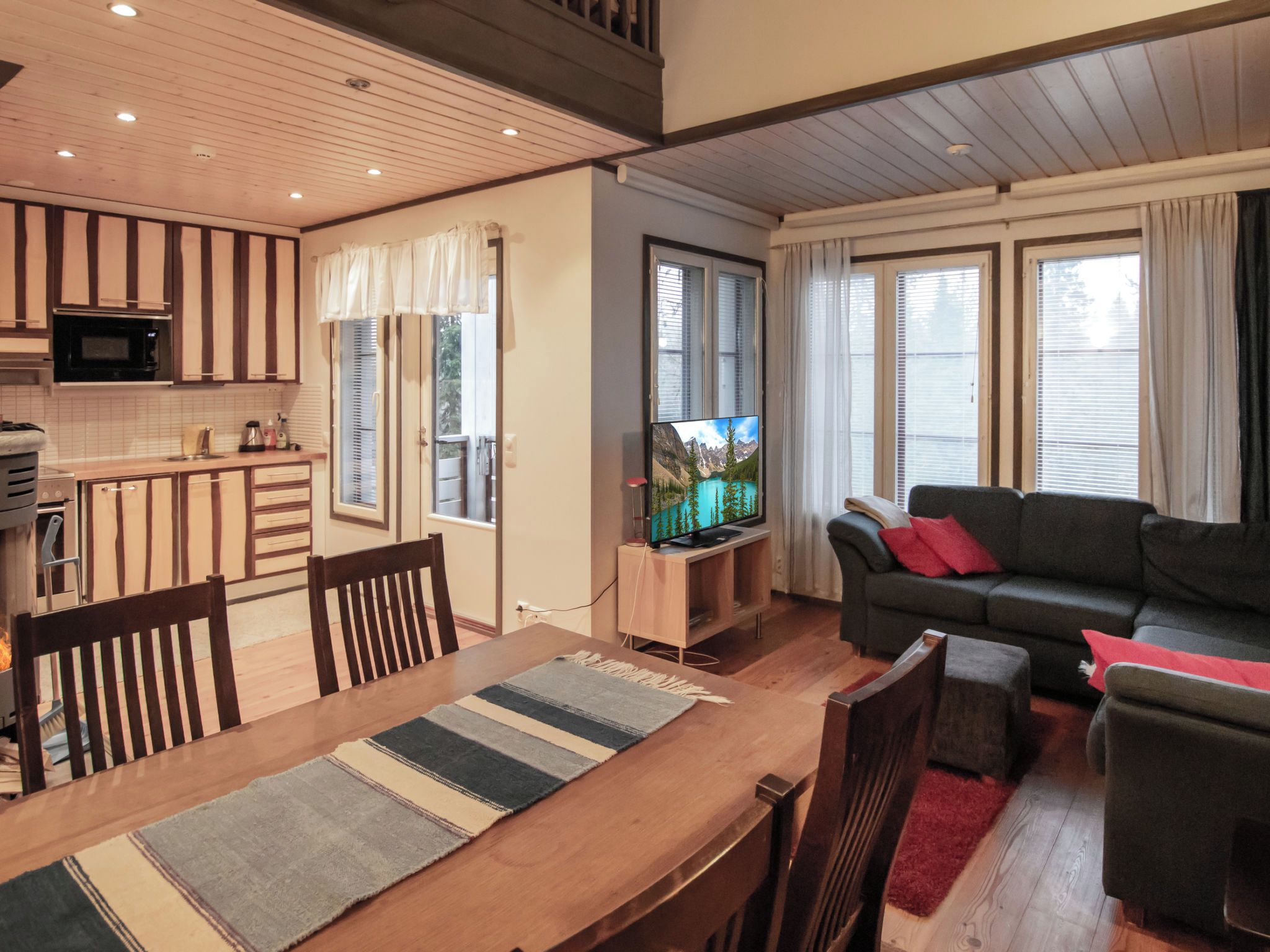 A modern living space with a kitchen, dining area, and seating area.