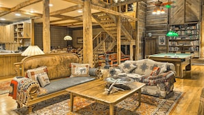A rustic interior with a wooden staircase, a pool table, and a cozy seating area with a sofa and armchairs. - River Access, Mtn Views! All-Season Cullowhee Base (Cullowhee)