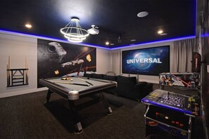 A room with a pool table, a Star Wars arcade game, a large screen displaying 'UNIVERSAL', and a space-themed wall mural. - Golf Front Reunion Villa, Cinema-Games, Spa & Pool (Reunion)