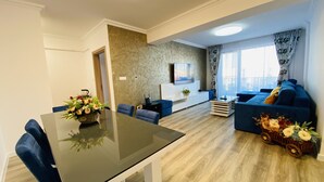 Family Apartment | Living area | 110-inch LED TV with digital channels, TV, Netflix - Charming Flat with Balcony & Parking (Craiova)