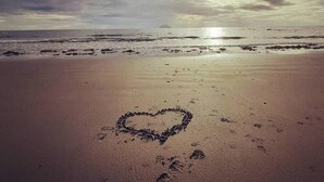 A beach with footprints and a heart drawn in the sand, under a cloudy sky. - Stunning Riverside Town House With Views, Ayrshire (Girvan)