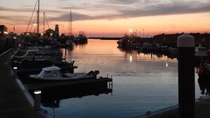A marina at dusk with boats docked, calm water, and a clear sky. - Stunning Riverside Town House With Views, Ayrshire (Girvan)
