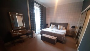 A bedroom with a bed, a dresser, a mirror, and a window with curtains. - Stunning Riverside Town House With Views, Ayrshire (Girvan)