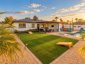 A residential backyard with a swimming pool, a barbecue area, and a patio with outdoor furniture. - The Eldorado | Two Masters | Pool + Hottub | Mural (Scottsdale)