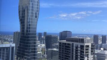 A modern skyscraper with a unique twisted design, surrounded by other high-rise buildings in a cityscape.