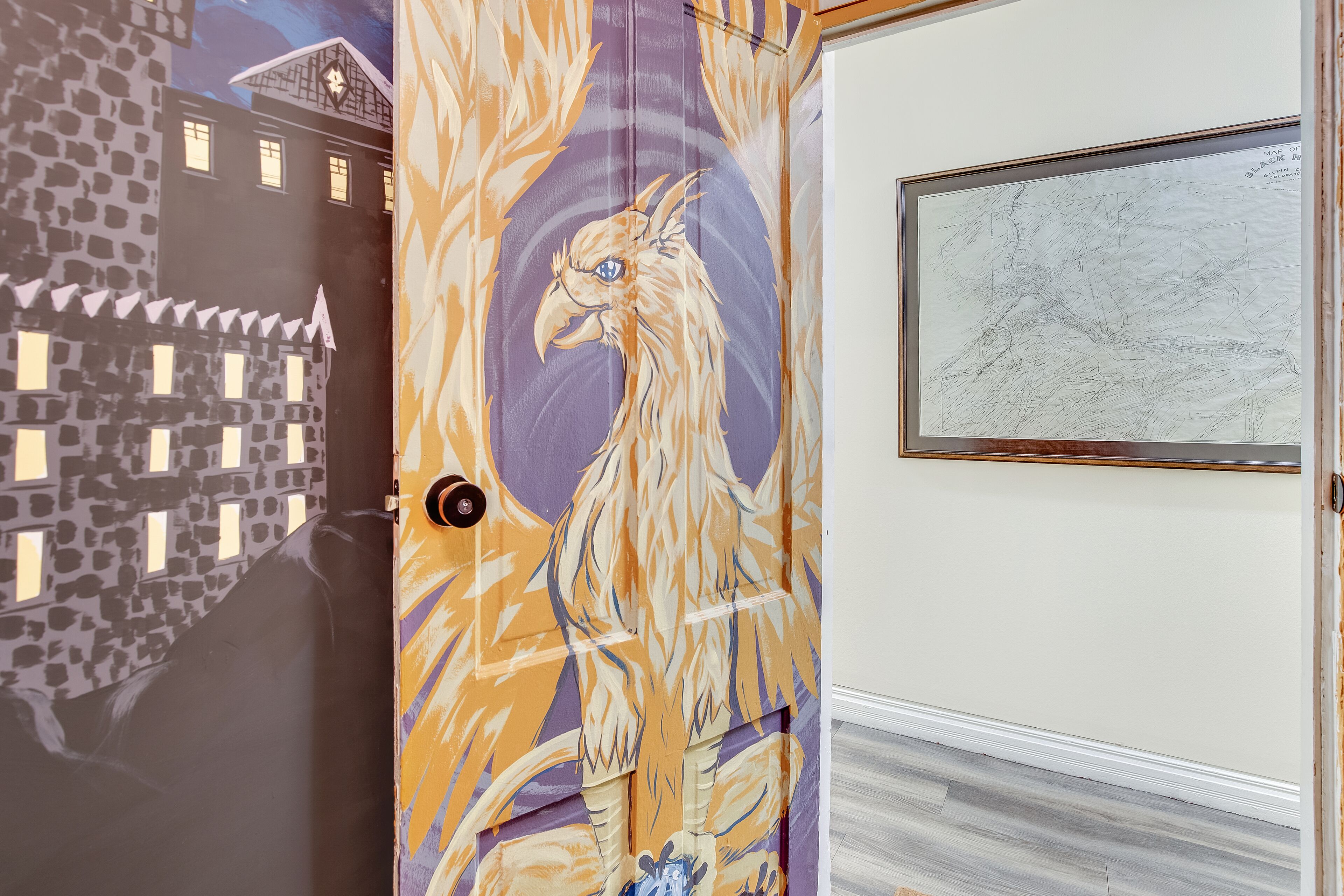 A door with a mural of a bird and a building.