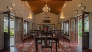 A dining area with a high ceiling, chandeliers, and a patterned floor. - Tree of Life Darbargadh, Dared (Vav)