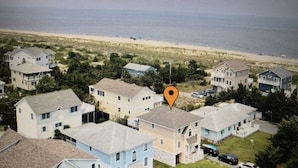 A residential area with multiple houses, a central road, and a marker indicating a specific location. - Steps From The Beach and Minutes to The Boards - Now Includes Linens (Milton)