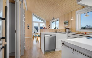 Enjoy cooking in this well-equipped kitchen with a dishwasher, countertop, and dining area.