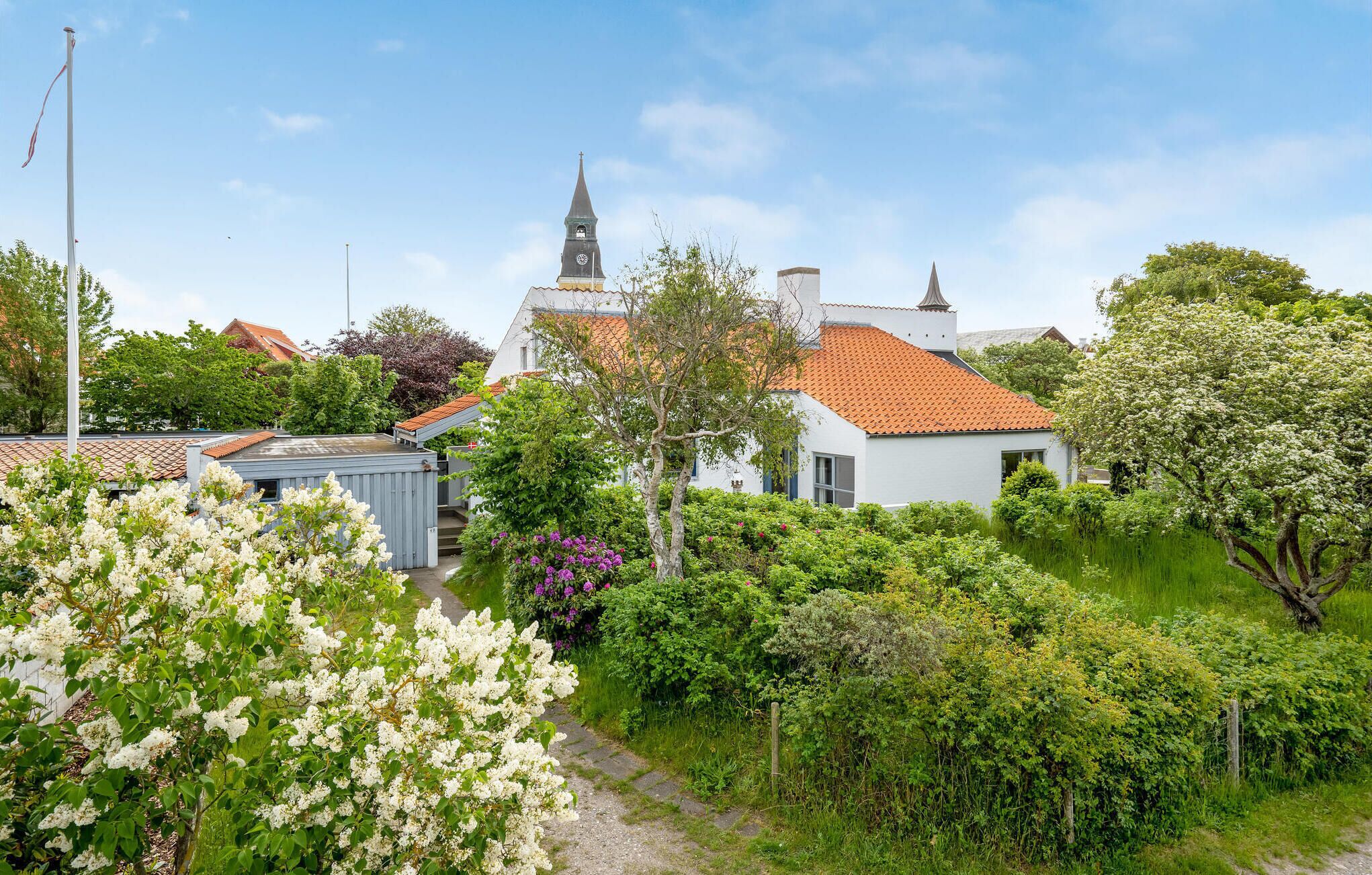En traditionell europeisk by med en kyrka som har ett högt torn och ett klocktorn.