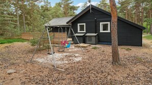 A cabin with a swing set and a satellite dish. - 4 bedroom nice home in Nexø (Nexø)