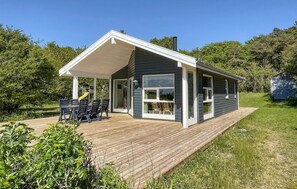 A modern house with a covered patio, large windows, and a deck. - 2 bedroom stunning home in Hasle (Hasle)