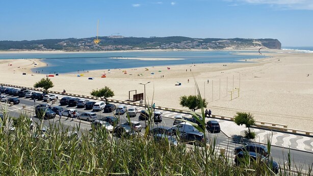 A coastal road with a beach in the background. - Beautiful villa with ocean & lagoon views,  walk to the beach! (Vau)