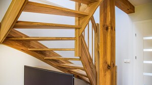 A wooden staircase with a simple design, leading to a landing area.