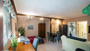 A compact living space with a dining area, kitchenette, and a bed. - Stunning apartment in Kucice (Kucice)