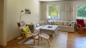A cozy living room with a sofa, chairs, a table, and a window with curtains. - 4 bedroom lovely home in Näsum (Näsum)