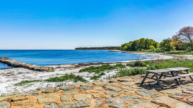 A beach with a stone walkway and picnic tables. - Lovely home in Nexø with WiFi (Nexø)