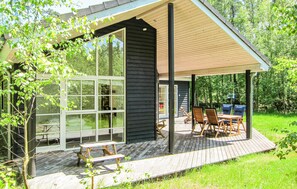 A modern house with a covered patio, large windows, and outdoor seating. - 4 bedroom amazing home in Nexø (Nexø)