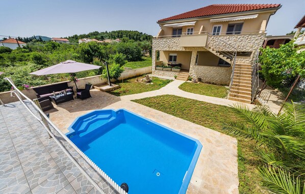 Una piscina al aire libre, tumbonas