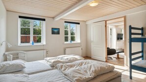 A bedroom with a bed, a chair, a desk, and a bunk bed. - 2 bedroom awesome home in Nexø (Nexø)