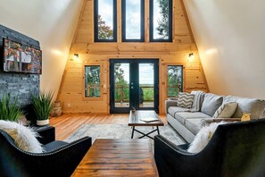 Relax in this inviting space with a comfortable sofa, flat-screen TV, and a dining area for two.