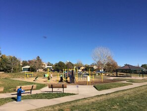 A park with playground equipment, benches, and a pavilion. - Mountain-View 5BR Retreat: Gym, Hot Tub, BBQ, Firepit, Playground, Sleeps 12 (Colorado Springs)